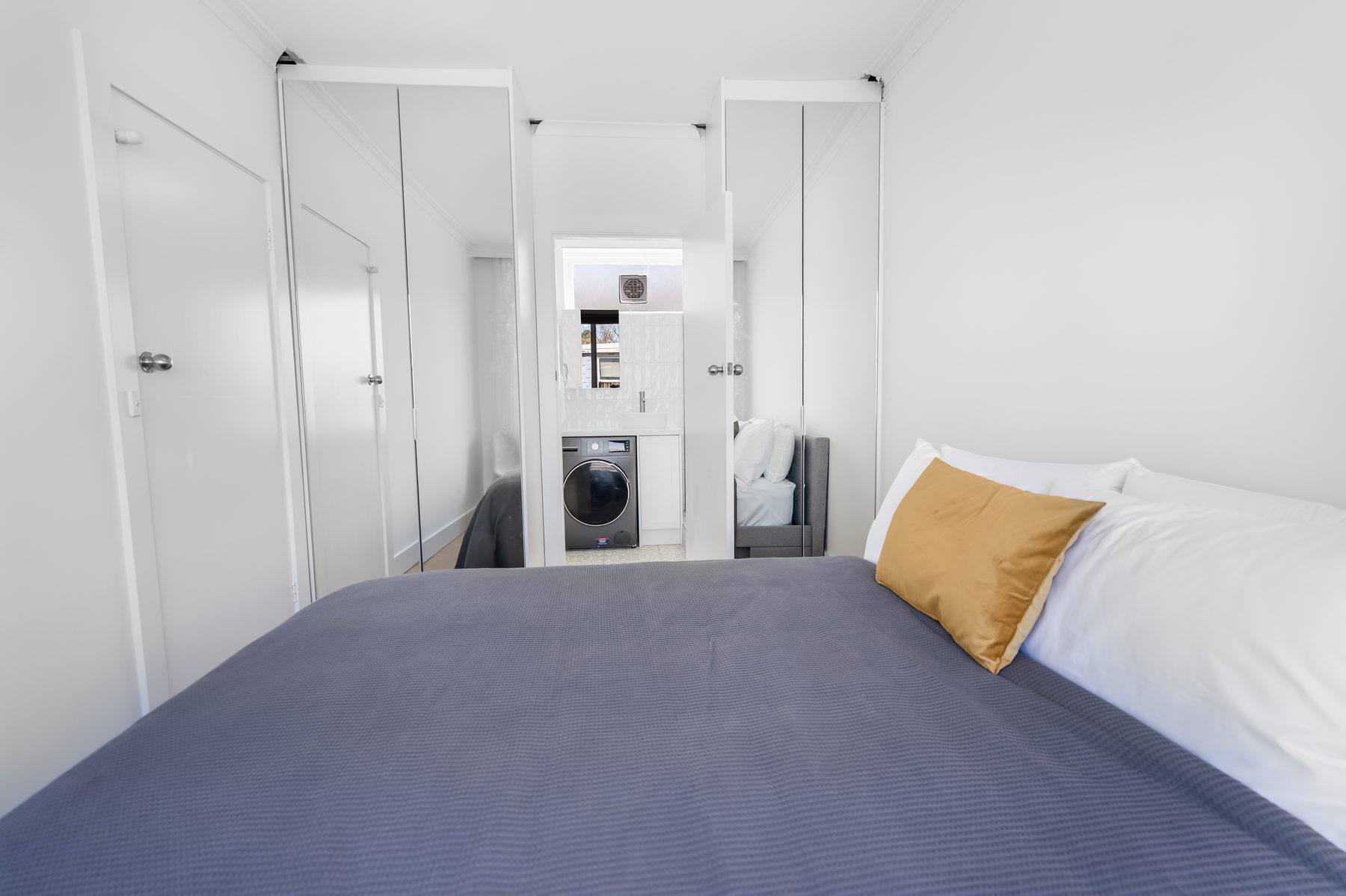 Bedroom with built-in wardrobes and ensuite laundry in a Melbourne apartment