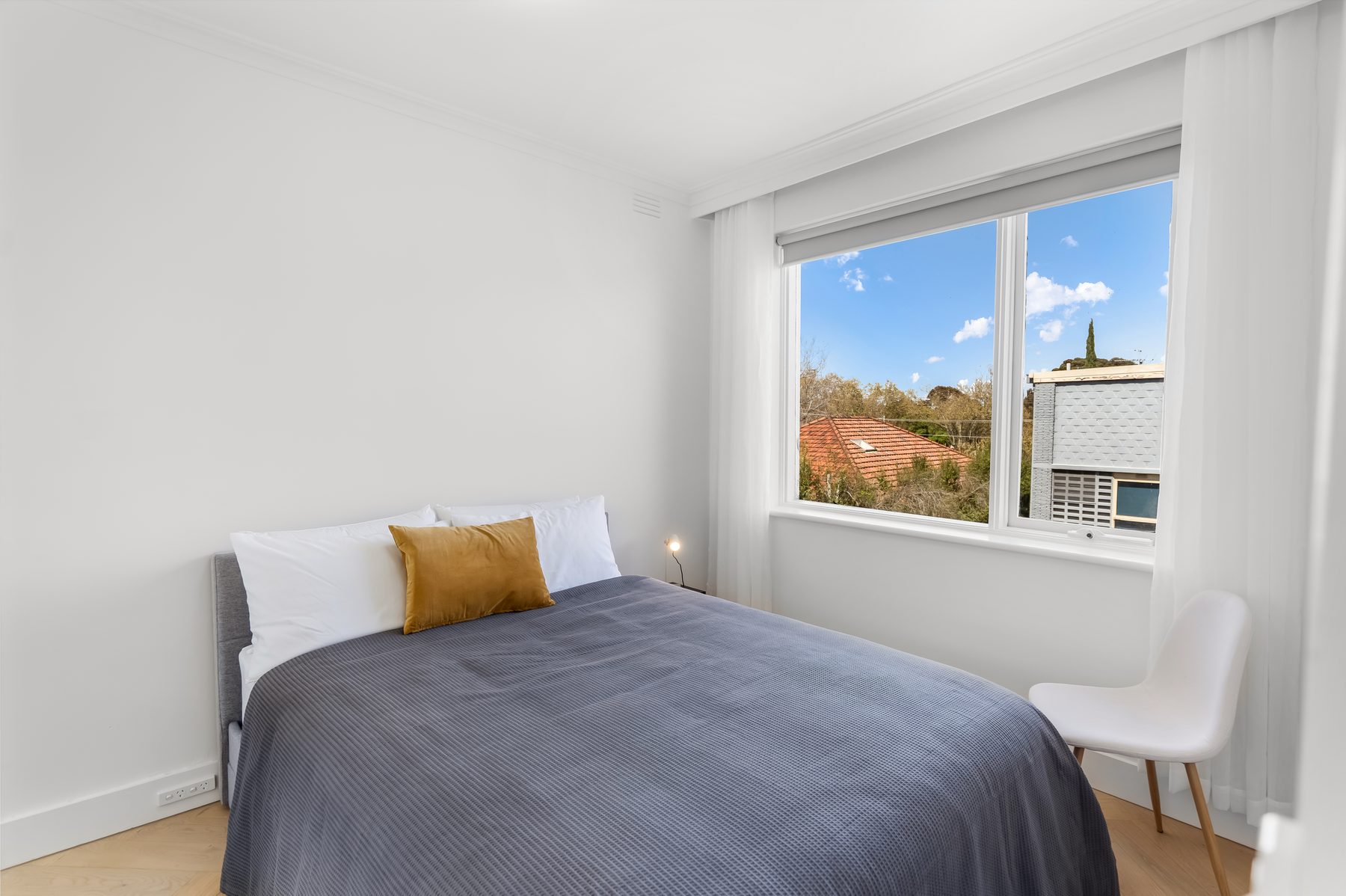 Bedroom with natural light in a Melbourne short-stay apartment