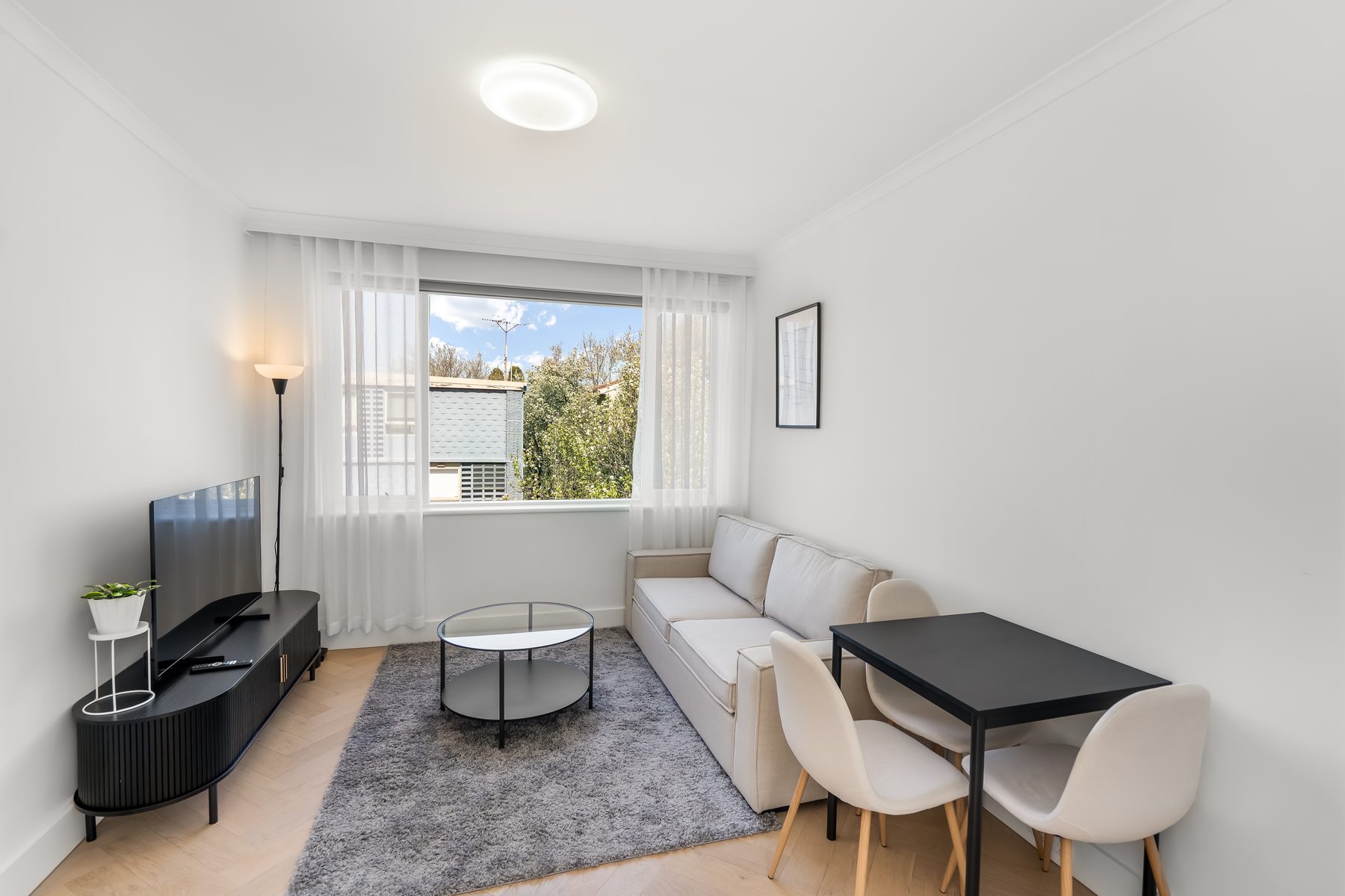 Bright living and dining area in a Melbourne short-stay apartment, photographed by CheckedIn Photography